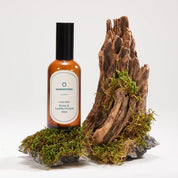 Bottle of Mangosteen product on a natural wooden and moss background