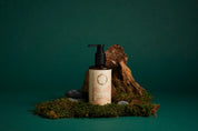 Skincare bottle with pump on a green background