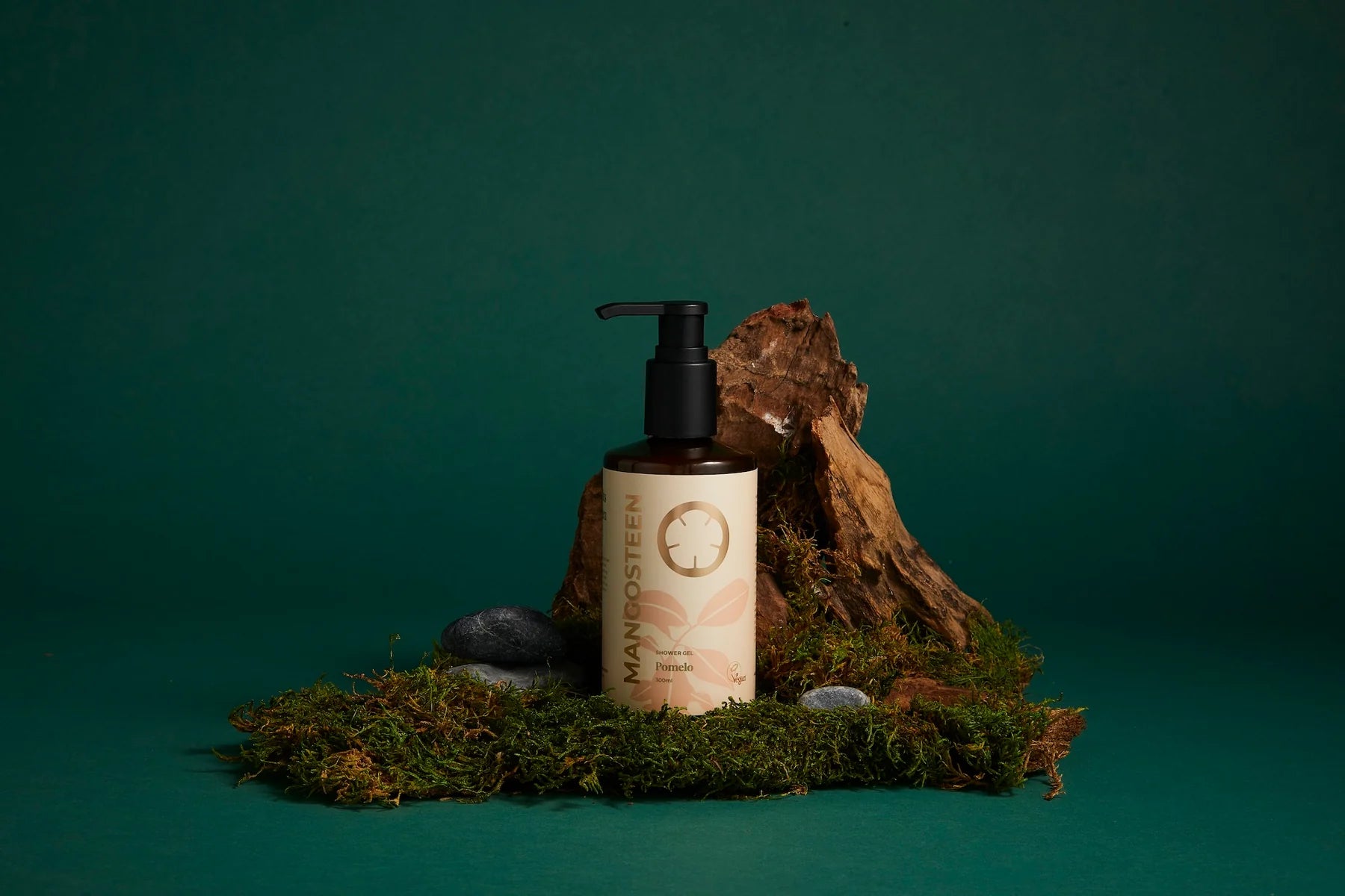 Skincare bottle with pump on a green background