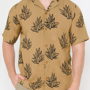 a closeup of batik cuban shirt in the pattern tan olive leaf