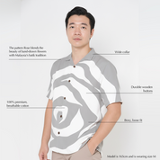 Man wearing a gray and white patterned shirt with text describing its features on a white background