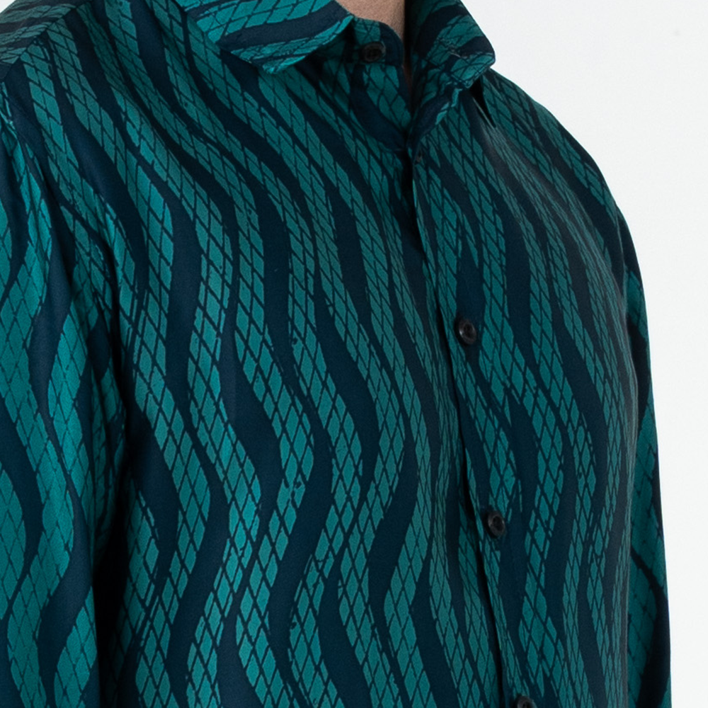 Close-up of teal Snakeskin batik shirt highlighting intricate hand-painted batik details and wooden buttons.