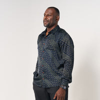a man standing in front of white background styling batik long sleeved in navy alur pattern