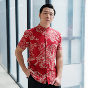 a man wearing a batik shirt with mandarin collar in the pattern crimson orchid