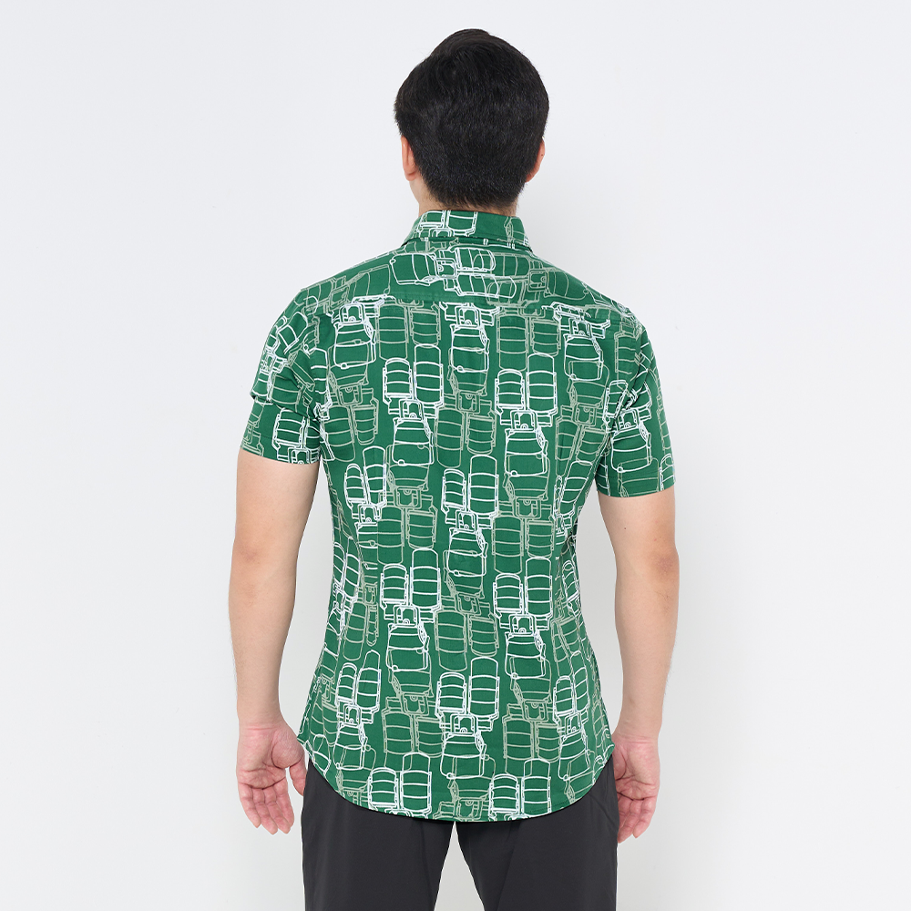 a man showcasing the design on the back of batik shirt in green tiffin