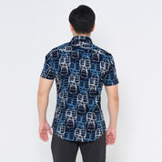 a male model showcasing the back of batik shirt in the pattern navy tiffin 