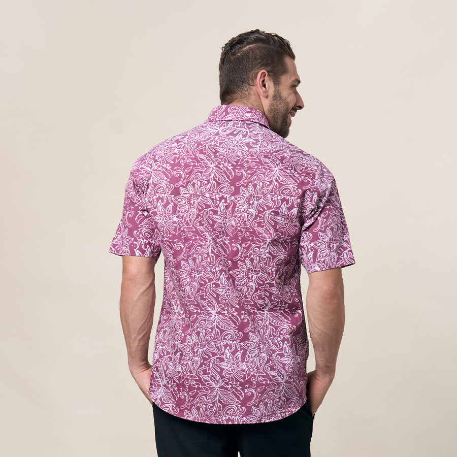 A captivating shot capturing a man with his back to the camera, highlighting the intricate details of the Pink Floret pattern on his stylish batik shirt