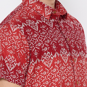 a closeup shot of a batik shirt in the pattern red anyam against a white background