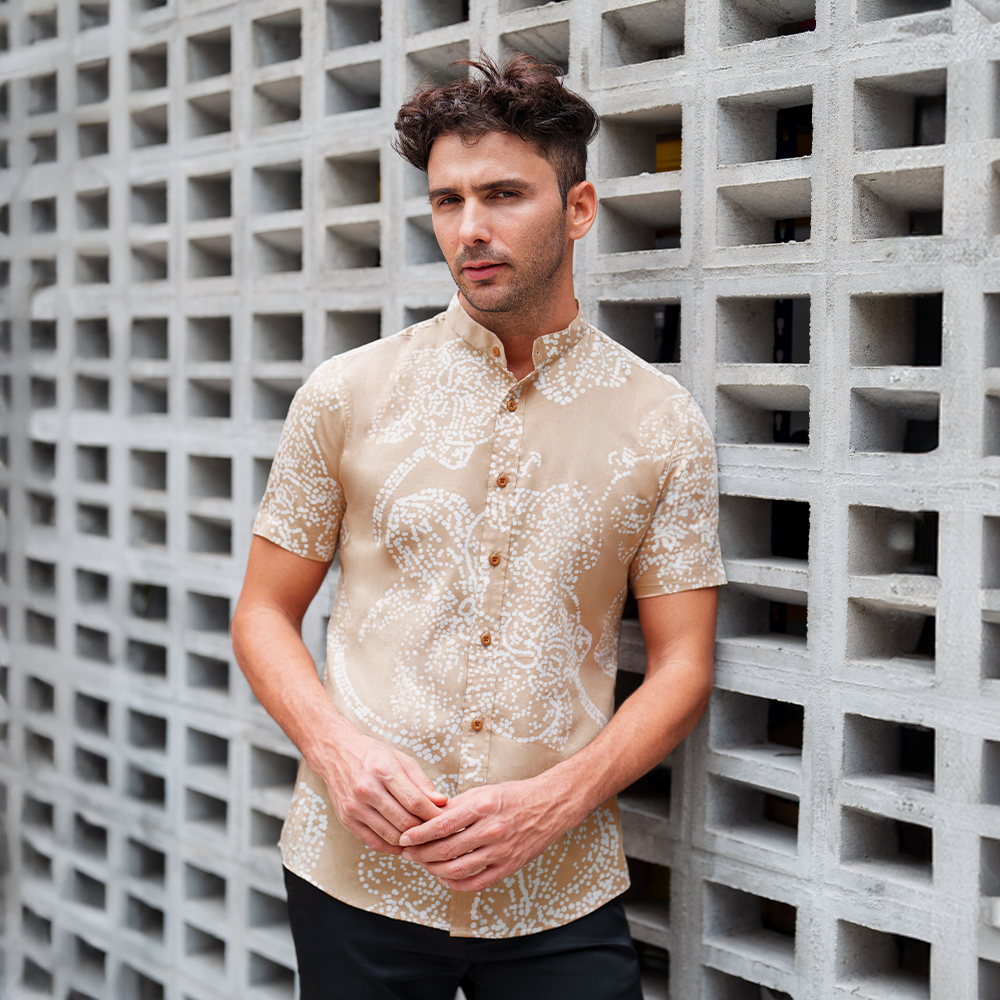 a man wearing a batik shirt in the pattern tan orchid with mandarin collar