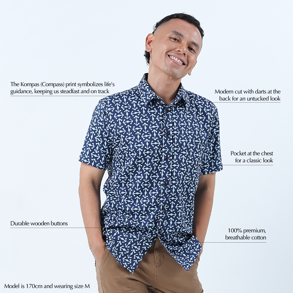 a man wearing a navy kompas batik shirt against a white background