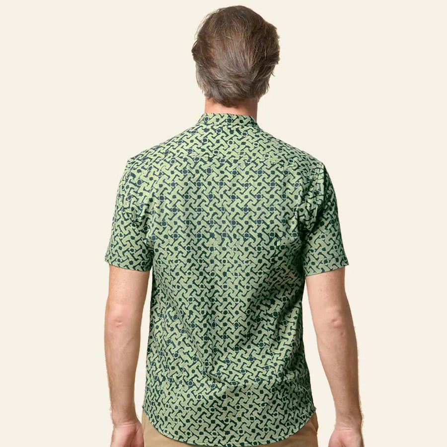 A male model confidently showcasing the exquisite details of the Forest Arabesque batik shirt with his back to the camera, set against a neutral background