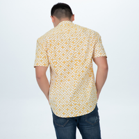 a photo showcasing the details on the back of a man wearing a batik shirt in the pattern mustard arabesque