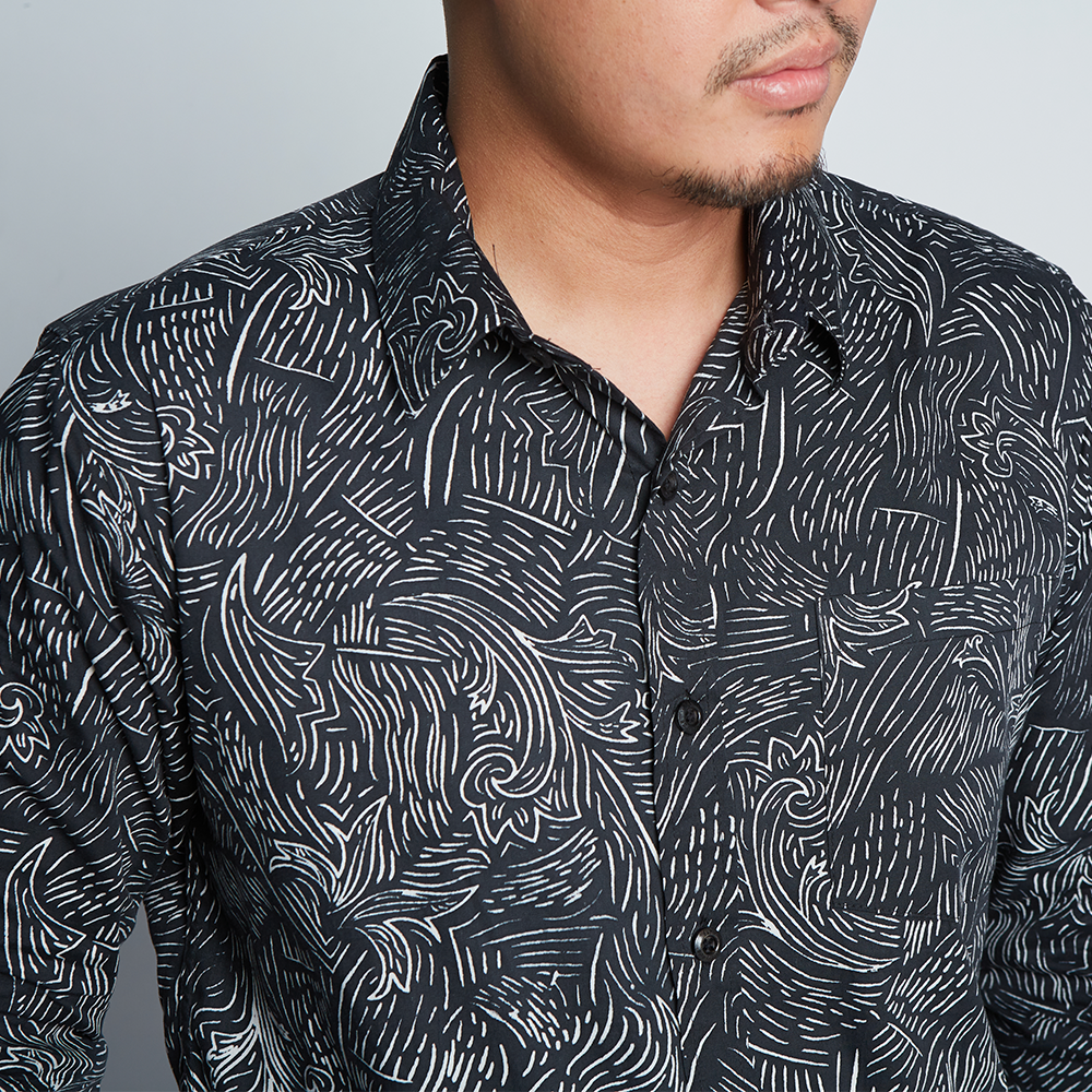 A close-up photograph accentuating the exquisite pattern of an authentic batik shirt against a neutral background