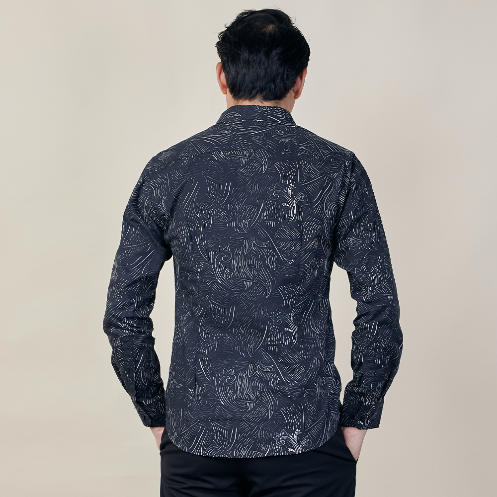 An image highlighting the intricate details on the back of a Black Driftwood patterned batik shirt, set against a neutral background