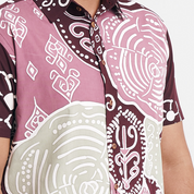 Close-up of the Maroon Petola batik shirt, showcasing intricate patterns and wooden buttons