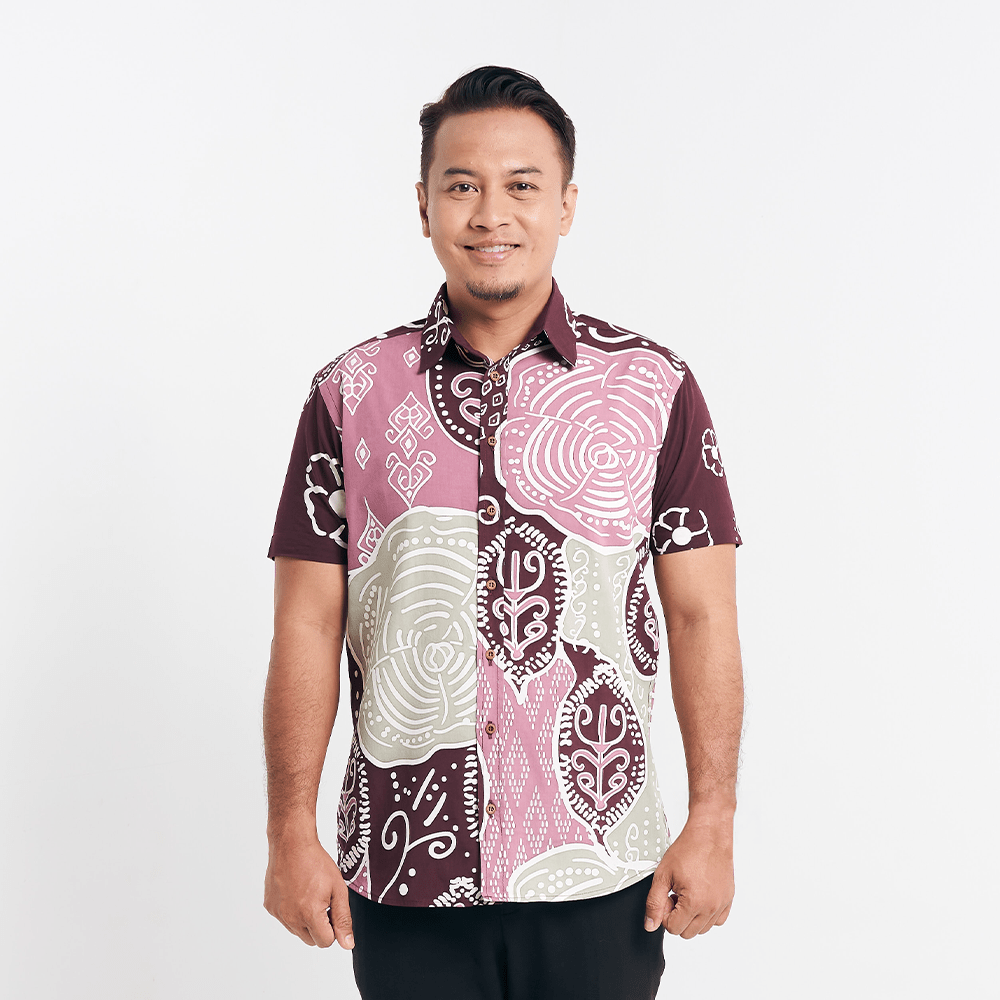Man in a Maroon Petola batik shirt standing against a white background, displaying front details