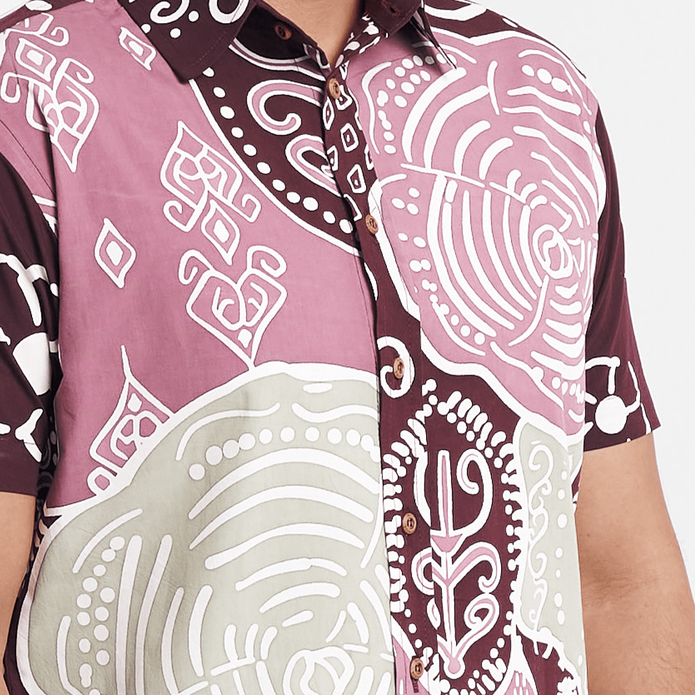 Close-up of the Maroon Petola batik shirt, showcasing intricate patterns and wooden buttons