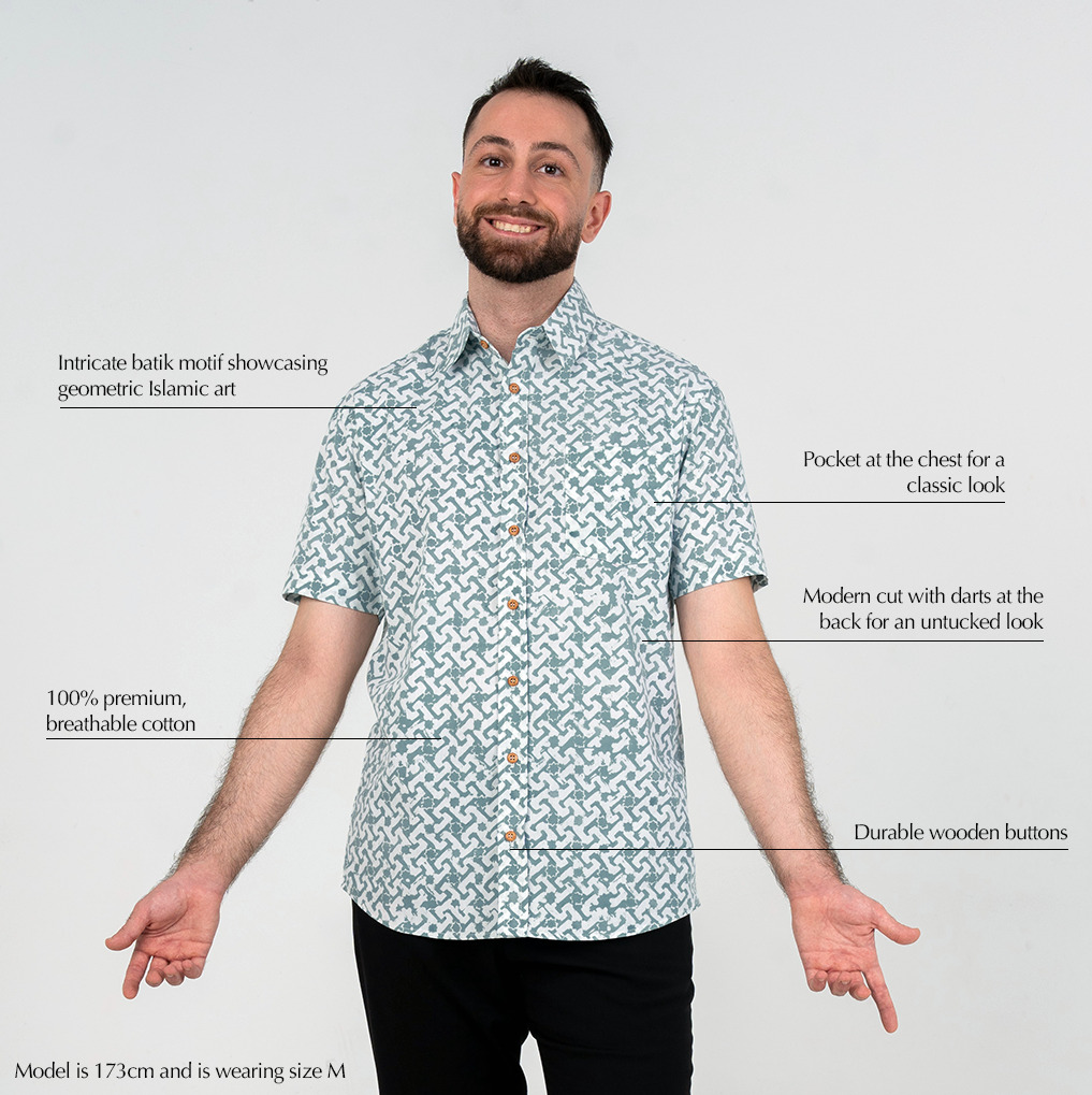 Man wearing teal Arabesque batik shirt with product features highlighted.