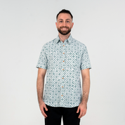 Front view of man wearing teal Arabesque batik shirt.