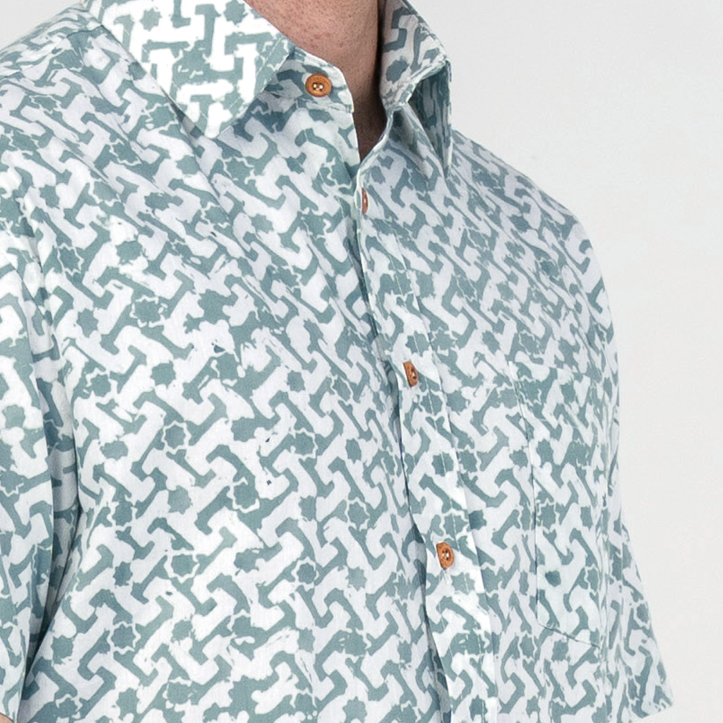 Close-up of collar and chest details on teal Arabesque batik shirt.