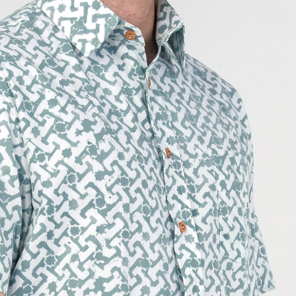 Close-up of collar and chest details on teal Arabesque batik shirt.