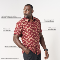 A man is wearing red color batik short sleeve shirt in Nasi Lemak, a renowned cultural dish in Malaysia. Batik shirt is made in cotton material, using technique of traditional batik technique
