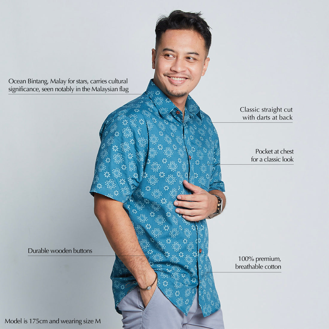 a man standing in front of white background styling batik shirt sleeved in ocean Bintang pattern  