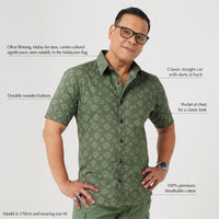  a man standing in front of white background styling batik short sleeved in olive Bintang pattern
