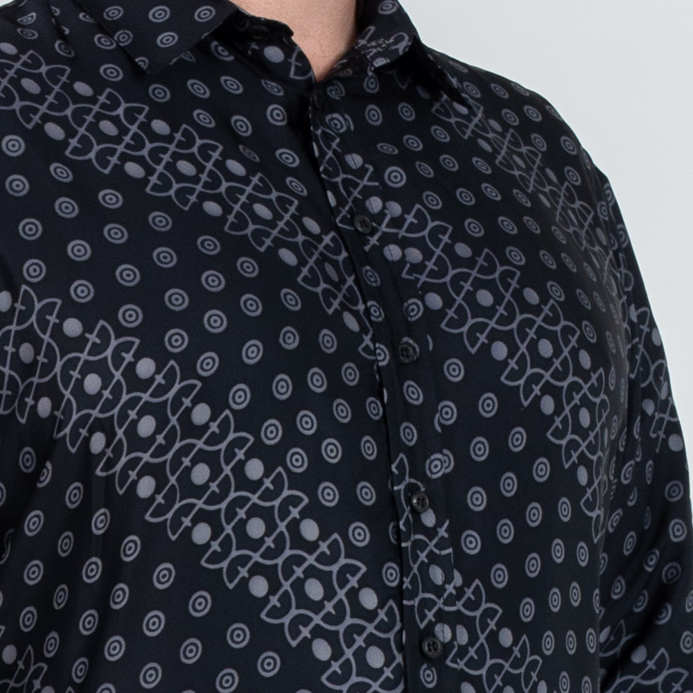 Close-up of Jet Alur batik shirt showing black silk cotton fabric with intricate circle and grid pattern