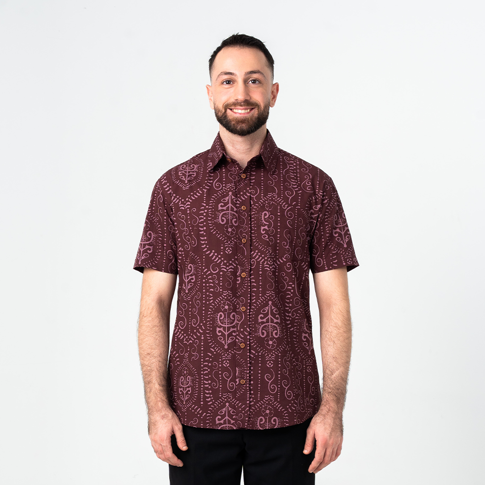 Front view of men's batik shirt in Garnet Petola featuring short sleeves, wooden buttons, and a heritage print