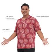 A man wearing a short-sleeve button-up shirt with a red and white palm leaf pattern, shown against a plain white background with text callouts describing the shirt's features.