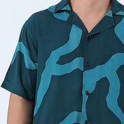 close up photo of men's cuban shirt in forest chain 