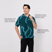 Man wearing a green patterned shirt on a white background