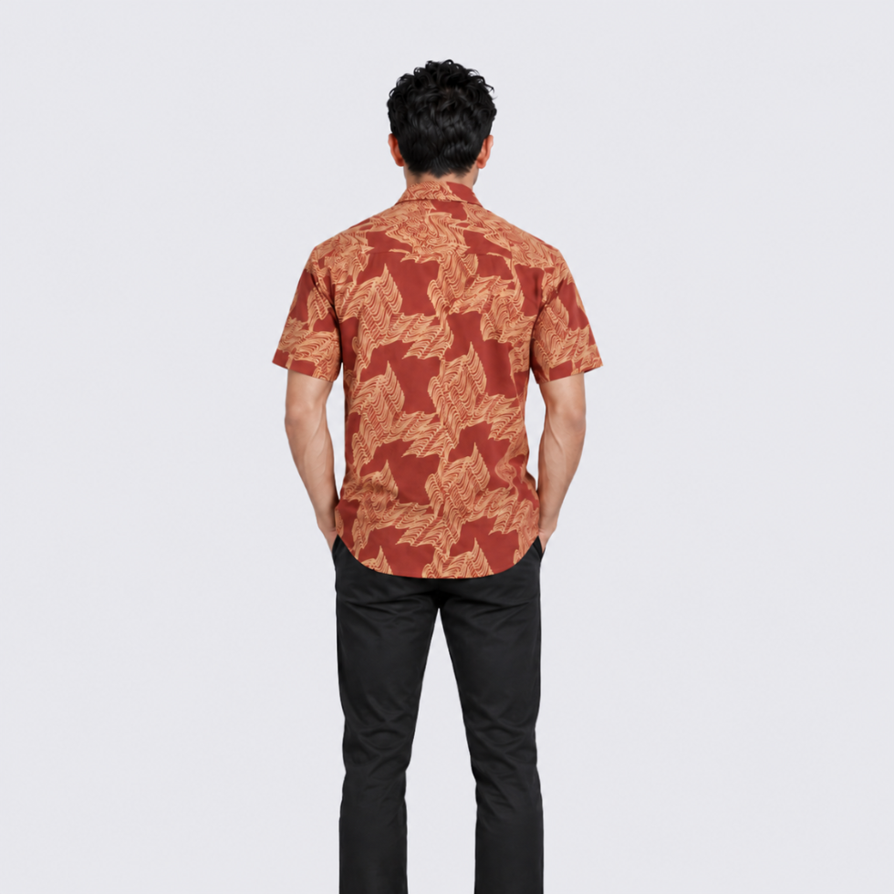 Man wearing orange printed batik shirt facing the back