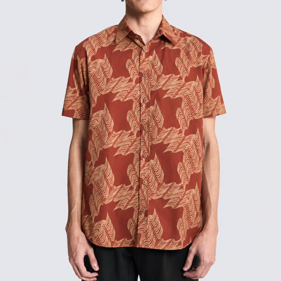 Closeup of man wearing orange printed batik shirt
