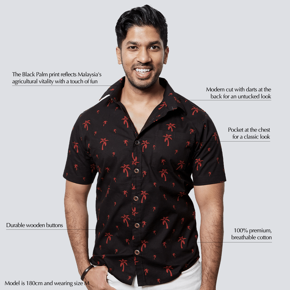 Man wearing a black shirt with red patterns on a white background