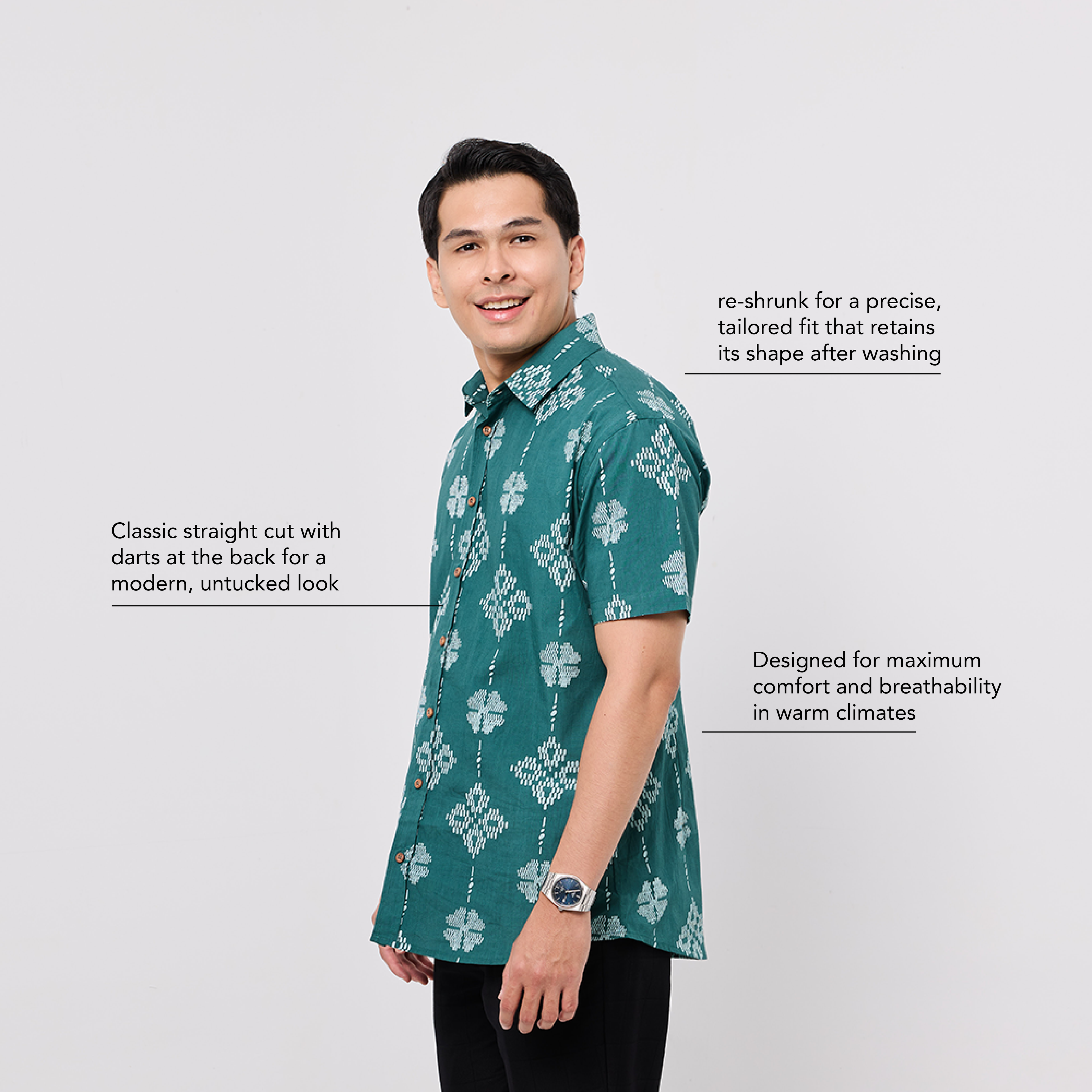 Man wearing a green floral shirt on a light gray background