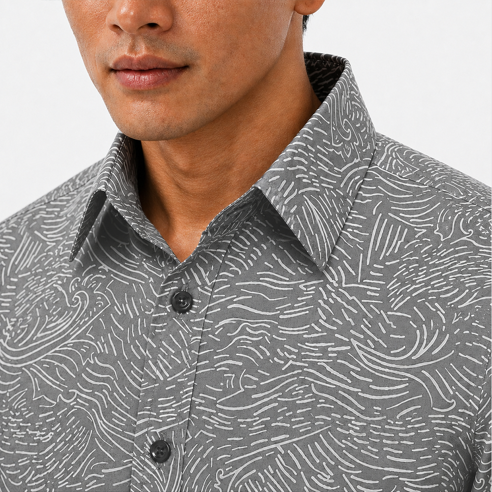 Man wearing a gray patterned shirt with a close-up of the collar.