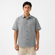 Man wearing a patterned short-sleeve shirt on a white background