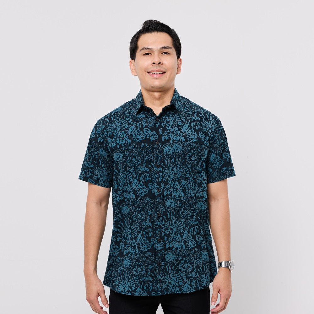 Man wearing a blue patterned shirt on a white background