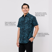 Man wearing a blue patterned shirt on a light gray background