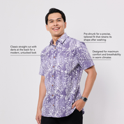 Man wearing a purple patterned Batik shirt on a white background