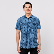 Man wearing a blue patterned shirt on a white background