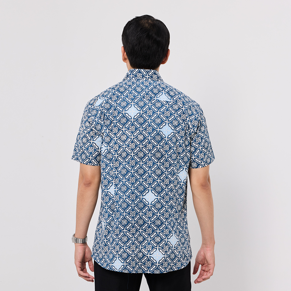 Man wearing a blue patterned shirt on a white background