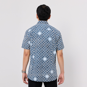 Man wearing a blue patterned shirt on a white background