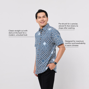 Man wearing a blue patterned shirt on a white background