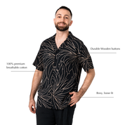 black wearing batik shirt with blue leaf-like patterns