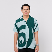 Man wearing a patterned shirt on a plain background