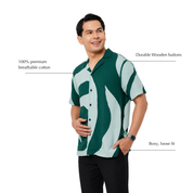 Man wearing batik shirt with green rose-like patterns