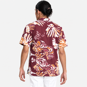 Man wearing maroon printed batik facing back